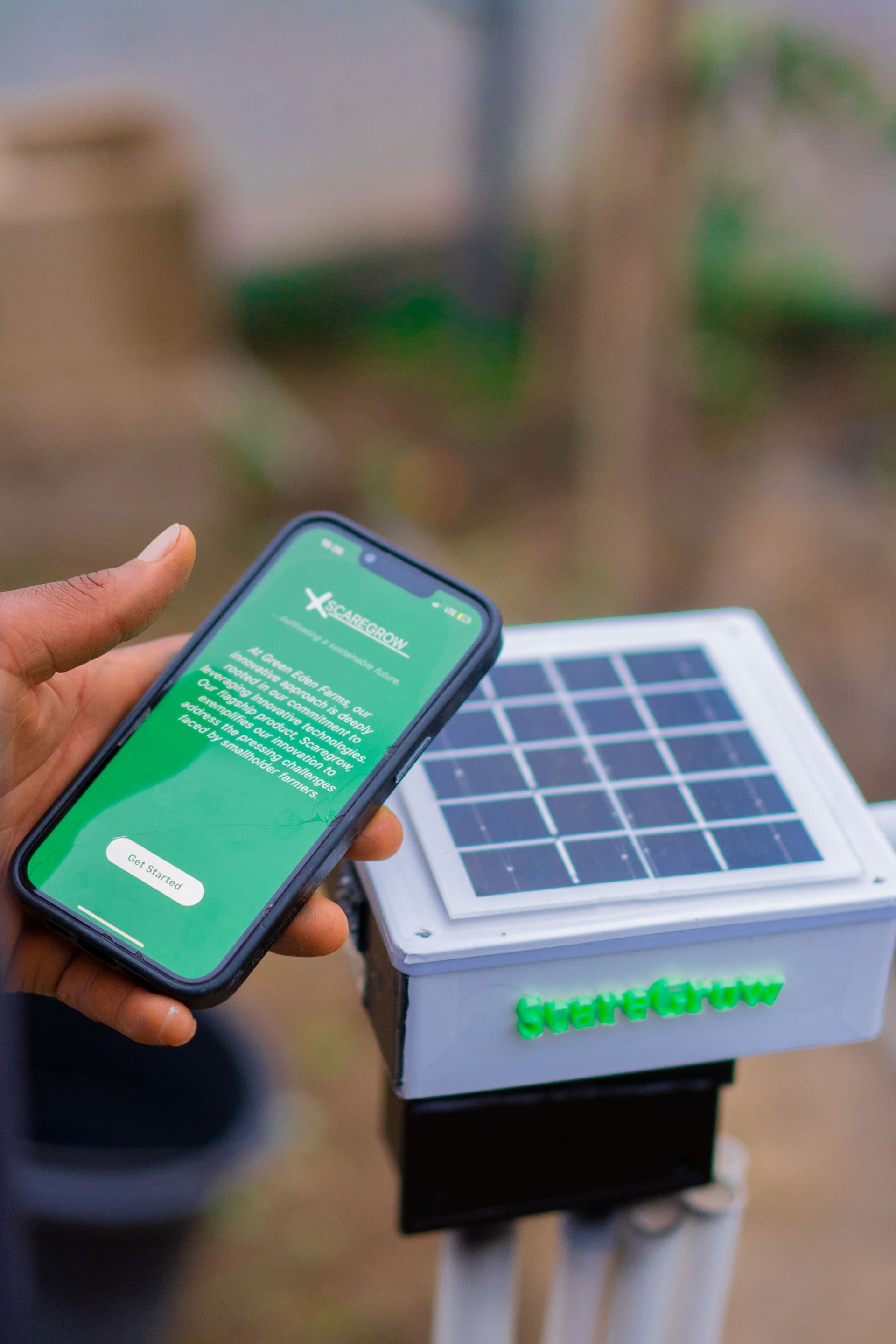 Farmer holding a tablet with a farm analytics dashboard in a field